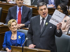 Ontario Finance Minister Charles Sousa delivers the provincial budget at the Ontario legislature, while Ontario Premier Kathleen Wynne looks on in Toronto, Ont. on Wednesday. Ernest Doroszuk/Postmedia Network