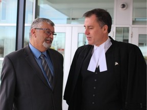 Former Sarnia fire chief Patrick Cayen, left, talks with his lawyer Phillip Millar after being acquitted of 24 sexual offences. (NEIL BOWEN/Postmedia Network)