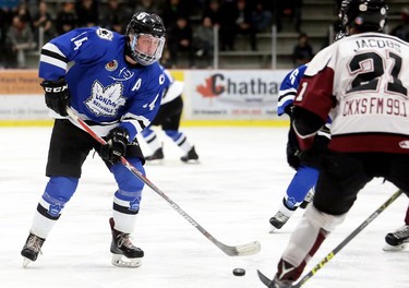 London Nationals' Brandon Glover (14) carries the puck against Chatham Maroons' Aaron Jacobs (21) in the first period of Game 3 in their GOJHL Western Conference semifinal at Chatham Memorial Arena in Chatham, Ont., on Sunday, March 18, 2018. Mark Malone/Chatham Daily News/Postmedia Network