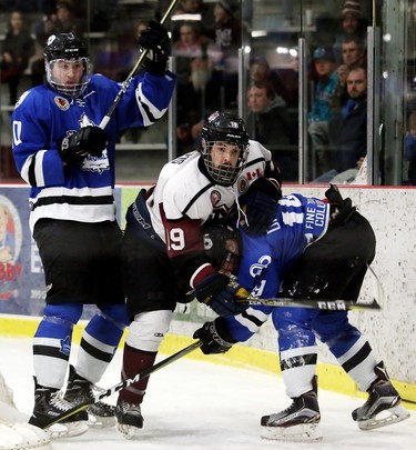 Chatham Maroons' Ryan Sarris, centre, battles London Nationals' Riley MacRae, left, and Kyle Dawson behind the Maroons' net in the first period of Game 3 in their GOJHL Western Conference semifinal at Chatham Memorial Arena in Chatham, Ont., on Sunday, March 18, 2018. Mark Malone/Chatham Daily News/Postmedia Network