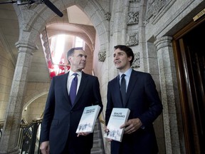 Minister of Finance Bill Morneau walks with Prime Minister Justin Trudeau before tabling the budget in the House of Commons on Parliament Hill in Ottawa. (CANADIAN PRESS)