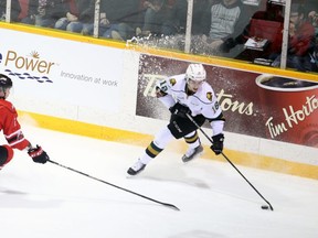 Liam Foudy of the London Knights tries to shake Owen Sound's Jacob Friend in the first period of Game 1 of an Ontario Hockey League best-of-seven Western Conference quarterfinal Thursday in Owen Sound. The Attack won 5-4. Greg Cowan/The Sun Times.