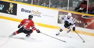 Liam Foudy of the London Knights tries to shake Owen Sound's Jacob Friend in the first period of Game 1 of an Ontario Hockey League best-of-seven Western Conference quarterfinal Thursday in Owen Sound. The Attack won 5-4. Greg Cowan/The Sun Times.