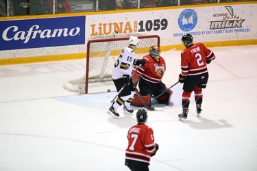 London Knights forward Alex Formenton's shot gets past Owen Sound Attack goaltender Olivier Lafreniere for the Knights' second goal as Jacob Friend of the Attack and Cole Tymkin of the Knights look on in the first period of Game 1 of an Ontario Hockey League best-of-seven Western Conference quarterfinal Thursday in Owen Sound.  The Attack won 5-4. Greg Cowan/The Sun Times.