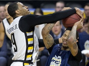 Marion Henry of the St. John's Edge gets crowned by Doug Herring Jr. of the London Lightning as the two battle for a rebound during their NBA basketball game in London, Ont. on Wednesday January 17, 2018.  (Derek Ruttan/The London Free Press)