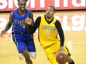 Kitchener-Waterloo Titan Anthony Myles chases after Doug Herring Jr. of the London Lightning during their NBL game at Budweiser Gardens  in London, Ont. on Sunday February 11, 2018.  (Derek Ruttan/The London Free Press)