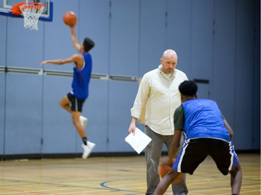 H.B. Beal head coach Ian McConnell acts as an obstacle during a dribbling drill in their final week of practice before they head to OFSAA in Windsor next week. Photograph taken on Monday February 26, 2018.  (MIKE HENSEN, The London Free Press)