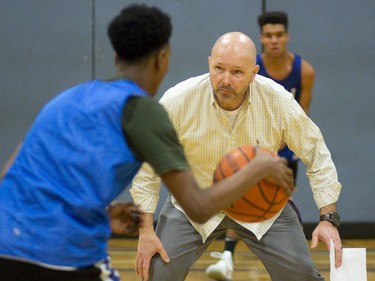 Beal Raiders head coach Ian McConnell acts as an obstacle during a dribbling drill in the team’s final week of practice before they head to the OFSAA basketball championship in Windsor next week. McConnell has guided the Raiders to OFSAA in five of his six seasons in charge. (MIKE HENSEN, The London Free Press)