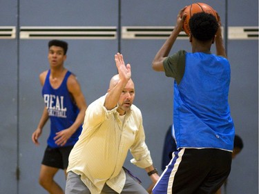 Beal Raiders head coach Ian McConnell acts as an obstacle during a dribbling drill in the team’s final week of practice before they head to the OFSAA basketball championship in Windsor next week. McConnell has guided the Raiders to OFSAA in five of his six seasons in charge. (MIKE HENSEN, The London Free Press)