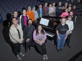 Students from H.B. Beal Singers surround David Weaver, who heads Beal’s music department, as he sits at a grand piano lent to the school by D & S Pianos for a concert Sunday that will also feature The London Singers. The show aims to raise money to help cover the costs of a trip to New York City’s Carnegie Hall, where the singers will perform. (Derek Ruttan/The London Free Press)