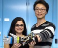 Engineering professor Ana Luisa Trejos and student Yue Zhou demonstrate a tremor suppression glove developed at Western University. The device offers people with Parkinson’s disease improved motor control. (Derek Ruttan/The London Free Press)