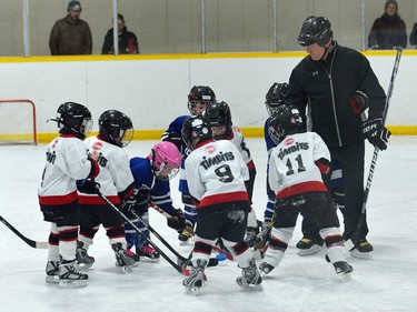 Players mass together for the face-off during a game of initiation level hockey at Oakridge arena.  MORRIS LAMONT/THE LONDON FREE PRESS /POSTMEDIA NETWORK