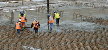 Workers pour over 1300 cubic meters of concrete forming a raft slab foundation for a new 24-floor residential tower on York Street at Thames street in London, Ontario on Tuesday March 6, 2018. The foundation will need 165 truck-loads of concrete some from as far away as Kitchener. The towers are hoped to be completed in early 2020. MORRIS LAMONT/THE LONDON FREE PRESS /POSTMEDIA NETWORK
