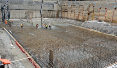 Workers pour over 1300 cubic meters of concrete forming a raft slab foundation for a new 24-floor residential tower on York Street at Thames street in London, Ontario on Tuesday March 6, 2018. The foundation will need 165 truck-loads of concrete some from as far away as Kitchener. The towers are hoped to be completed in early 2020. MORRIS LAMONT/THE LONDON FREE PRESS /POSTMEDIA NETWORK