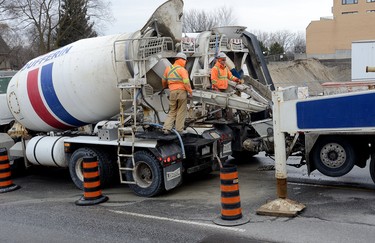 Workers pour over 1300 cubic meters of concrete forming a raft slab foundation for a new 24-floor residential tower on York Street at Thames street in London, Ontario on Tuesday March 6, 2018. The foundation will need 165 truck-loads of concrete some from as far away as Kitchener. The towers are hoped to be completed in early 2020. MORRIS LAMONT/THE LONDON FREE PRESS /POSTMEDIA NETWORK