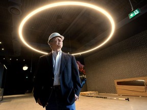 David Terry, vice-president of the Rec Room division of Cineplex, stands under a ring light measuring more than four metres in diameter that decorates the lobby of the new adult play space under construction at Masonville Place mall. The attraction is set to open April 30. (MORRIS LAMONT/THE LONDON FREE PRESS)