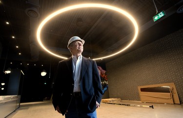David Terry, vice-president of the Rec Room division of Cineplex, stands under a ring light measuring more than four metres in diameter that decorates the lobby of the new adult play space under construction at Masonville Place mall. The attraction is set to open April 30. (MORRIS LAMONT/THE LONDON FREE PRESS)