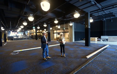 David Terry, vice-president and general manager of The Rec Room, and Sarah van Lange, director of communications, on the games floor that will host everything from axe throwing to virtual reality games stands under at The Rec Room under construction at Masonville Mall on Wednesday March 7, 2018. MORRIS LAMONT/THE LONDON FREE PRESS /POSTMEDIA NETWORK