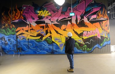 David Terry, vice-president and general manager of The Rec Room, admires a graffiti wall at The Rec Room under construction at Masonville Mall on Wednesday March 7, 2018. MORRIS LAMONT/THE LONDON FREE PRESS /POSTMEDIA NETWORK