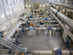 Andrew Henry, director Regional Water Supply, Kelly Scherr CAO of the two regional water boards, London mayor Matt Brown and Peter Barbour, chair of Elgin Area Water Board, look over the Southwest Pumping Station and Reservoir in London. )Derek Ruttan/The London Free Press)