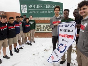 The MTS boys AA OFSAA basketball champions pose with their school sign and their brand new banner they won Wednesday night in Pembroke.
Left to right Aidan Forsythe, Kyle Chea, Lorenzo Hakizimana, Shemar Rodriguez, Juan Ortiz, Emmanuel Akindele, Peyton Campbell, Aaron Tennant, Oren Rusagara, Joshua Lawrence and Mitchell Hartman.
Photograph taken on Friday March 9, 2018. 
Mike Hensen/The London Free Press/Postmedia Network