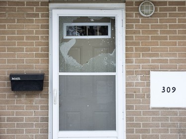 The glass in the screen door at 309 Marconi Blvd. is shattered after being hit by a shotgun blast early Tuesday morning. 
Derek Ruttan/The London Free Press