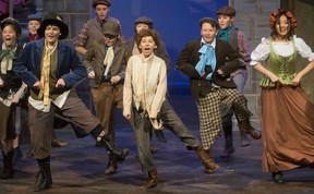 Connor Englert as the Artful Dodger, left, and Hope Wilson as Oliver, centre, sing and dance to Consider Yourself in Oliver! at the Palace Theatre in London Tuesday. Mike Hensen/The London Free Press