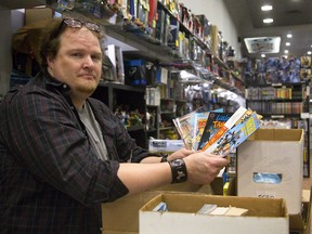 Christopher Runciman the store manager at Heroes on Dundas Street was busy labelling free comics for the annual Comic Book Jam Wednesday at the Central Library in London, Ont.  Photograph taken on Tuesday March 13, 2018.  (MIKE HENSEN, The London Free Press)
