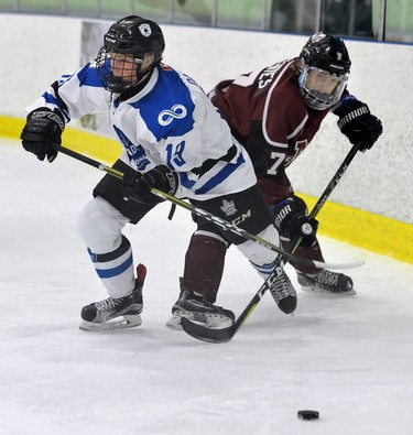 London Nationals Kyle Dawson battles Chatham defence man Dylan Schives for a loose puck during game one of their GOJHL semi-final series at the Western Fair Sports Centre on Wednesday March 14, 2018. MORRIS LAMONT/THE LONDON FREE PRESS /POSTMEDIA NETWORK