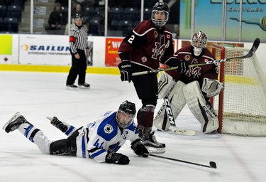 London Nationals captain Brenden Trottier hits the ice hard after trying to drive to the net with Chatham defence man Dakota Bohn and goaltender Ryan Wagner during game one of their GOJHL semi-final series at the Western Fair Sports Centre on Wednesday March 14, 2018. MORRIS LAMONT/THE LONDON FREE PRESS /POSTMEDIA NETWORK