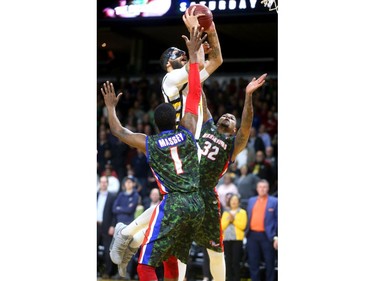 Royce White of the London Lightning goes up for two and a foul against Bruce Massey and  Chris Braswell of Cape Breton during their Thursday night game at Budweiser Gardens.
Mike Hensen/The London Free Press