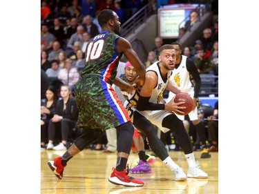 Garrett Williamson of the London Lightning fakes a drive baseline on Malik Story of Cape Breton before putting up a fade away during their Thursday night game at Budweiser Gardens.
Mike Hensen/The London Free Press