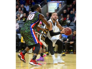 Garrett Williamson of the London Lightning fakes a drive baseline on Malik Story of Cape Breton before putting up a fade away during their Thursday night game at Budweiser Gardens.
Mike Hensen/The London Free Press