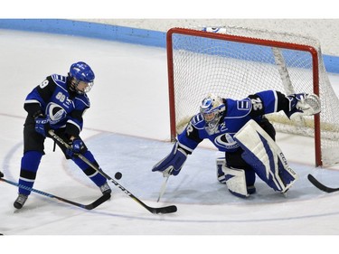 Montreal Carabins goaltender Marie-Pier Chabot drives for a loose puck with defenceman Audrey Lavaliere during their game in the Women's Hockey National Championship at Western University's Thompson Arena on Thursday. (MORRIS LAMONT/THE LONDON FREE PRESS)