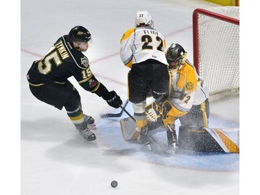 Sarnia Sting defenceman Mitch Eliot collides with goaltender Justin Fazio while trying to keep London Knights forward Cole Tymkin in check in first-period Ontario Hockey League action Friday at Budweiser Gardens.
MORRIS LAMONT/THE LONDON FREE PRESS