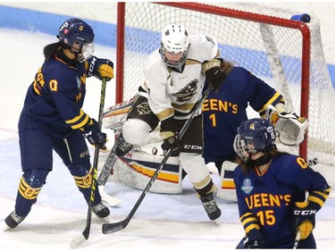 Courtlyn Oswald of the Manitoba Bisons redirects a shot past Queen's Gaels goaltender Stephanie Pascal as Devon Greenough and Bryce Desa of the Gaels defend in a U Sports women's championship quarterfinal Friday at Thompson arena.
Mike Hensen/The London Free Press