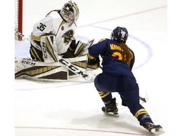 Manitoba Bisons goaltender Lauren Taraschuk makes a save on Katrina Manoukarakis of the Queen's Gaels on a breakaway in a U Sports women's championship quarterfinal Friday at Thompson arena. 
Mike Hensen/The London Free Press