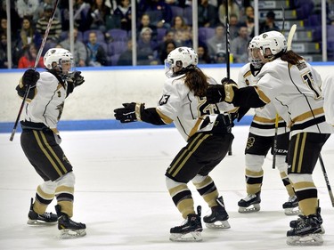 Manitoba Bisons Caitlin Fyten celebrates the winning goal with teammates Lauren Keen, and Eric Rieder during the Women's Hockey National Championship at at Western University's Thompson Arena on Sunday. Bisons won 2-0 over Western. MORRIS LAMONT/THE LONDON FREE PRESS /POSTMEDIA NETWORK ORG XMIT: POS1803181853043758