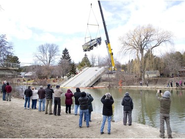 The removal of a dump truck from a collapsed bridge near Port Bruce on Friday, March 23, drew a crowd of onlookers with cameras. Derek Ruttan/The London Free Press