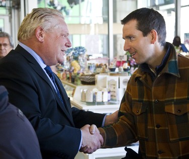 Doug Ford shakes hands with Matt Carapella at the Covent Garden Market. Ford stopped at the popular lunch spot on Monday to shake hands with Londoners as part of his campaign swing through southwestern Ontario on Monday March 26, 2018.  Mike Hensen/The London Free Press/Postmedia Network