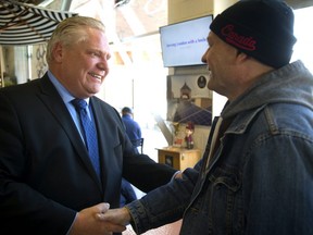 Doug Ford shakes hands with Todd Andress at the Covent Garden Market. Ford stopped at the popular lunch spot on Monday to shake hands with Londoners as part of his campaign swing through southwestern.  (Mike Hensen/The London Free Press)