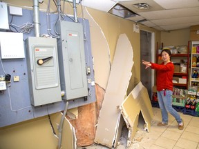 Nina Zhuang shows the damage to the rear of her York Street variety store after a car came through the back wall on early Sunday morning. Zhuang says a lot of supplies were knocked to the ground making a sticky mess, as well as almost knocking down their electrical panel in London.  (Mike Hensen/The London Free Press)