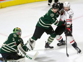 Shane Collins of the Knights keeps Jonah Gadjovich away from Knights goaltender Joseph Raaymakers as he makes a glove save during the first period of their recent playoff game. (MIKE HENSEN, The London Free Press)