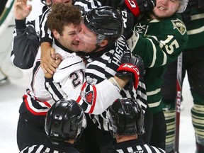 Cole Tymkin of the Knights gets a double roughing penalty in a scrum with Owen Sound's Jonah Gadjovich who got a cross check minor during the first period of their playoff game on Monday March 26, 2018 at Budweiser Gardens.  Mike Hensen/The London Free Press/Postmedia Network