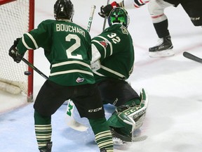 Brett McKenzie of the Owen Sound Attack almost nets his second of the first period as he shoots behind Knights goaltender Joseph Raaymakers and captain Evan Bouchard, but the puck carried on across the crease and out during the first period of their playoff game on Monday March 26, 2018 at Budweiser Gardens.  Mike Hensen/The London Free Press/Postmedia Network