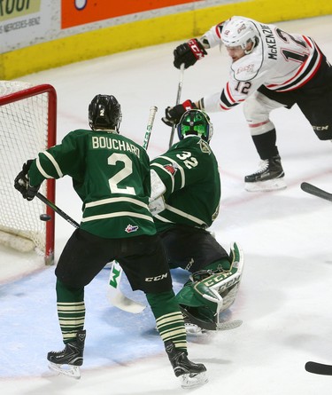 Brett McKenzie of the Owen Sound Attack almost nets his second of the first period as he shoots behind Knights goaltender Joseph Raaymakers and captain Evan Bouchard, but the puck carried on across the crease and out during the first period of their playoff game on Monday March 26, 2018 at Budweiser Gardens.  Mike Hensen/The London Free Press/Postmedia Network