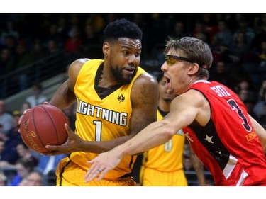 Kyle Johnson of the London Lightning drives in on Logan Stutz of the Windsor Express during the first quarter of their Wednesday night game at Budweiser Gardens in London, Ont.  Photograph taken on Wednesday March 28, 2018.  Mike Hensen/The London Free Press/Postmedia Network