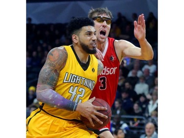 Julian Boyd of the London Lightning drives in on Logan Stutz of the Windsor Express during the first quarter of their Wednesday night game at Budweiser Gardens in London, Ont.  Photograph taken on Wednesday March 28, 2018.  Mike Hensen/The London Free Press/Postmedia Network
