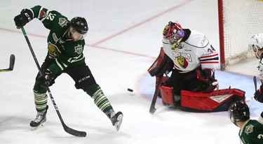 London Knights player Alex Turko tries to deflect a shot past Owen Sound goalie Olivier Lafreniere during the third period of their playoff game at Budweiser Gardens on Thursday March 29, 2018. 
Owen Sound won 2-1, winning the series with a four-game sweep.
Mike Hensen/The London Free Press/Postmedia Network