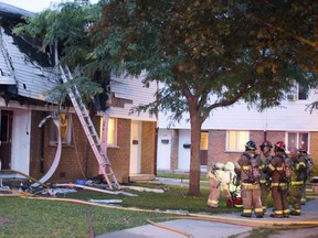 Firefighters on scene of an explosion in a townhouse on Southdale Road in London Ontario on Friday, August 15, 2014. (DEREK RUTTAN, The London Free Press)